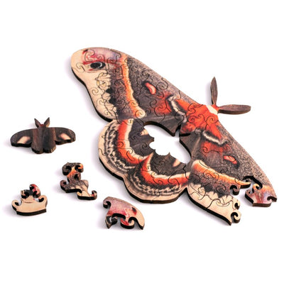 The Mini Moth Wood Puzzle by Nervous System showcases intricately designed jigsaw pieces, featuring a beautifully detailed moth and smaller puzzle fragments. This wooden puzzle combines art and play, making it a great gift for puzzle enthusiasts and nature lovers alike.