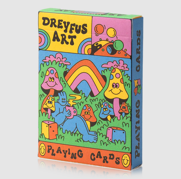 Dreyfus Card Deck by Art of Play featuring whimsical, colorful illustrations of mushrooms, a rainbow, and playful characters. The box showcases vibrant artwork that invites friendly gameplay.
