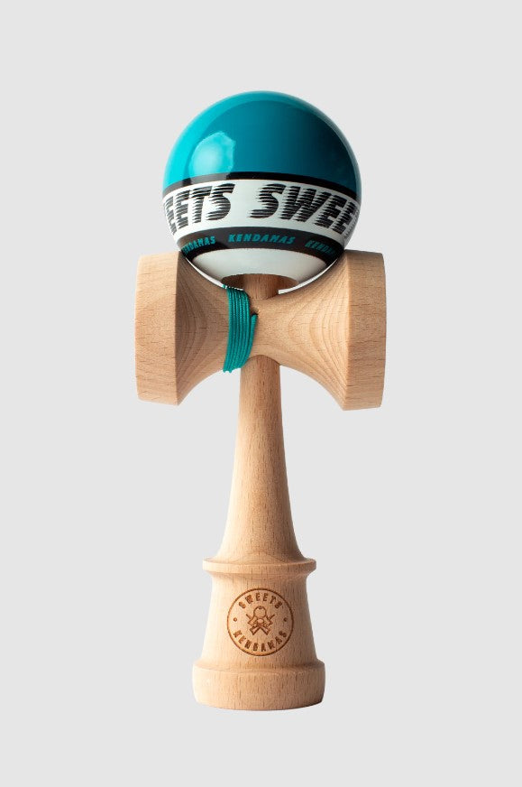 A close-up of the Starter Teal Kendama by Sweets Kendamas. The kendama features a glossy teal ball with a white stripe showing the brand name and a natural wood handle. The string connects the ball to the handle, allowing for engaging tricks and play.