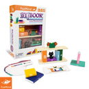 The 'By the Book' mechanical puzzle by FoxMind showcases colorful wooden pieces shaped like books, complete with a black cat figure and flower pots. The packaging features vibrant graphics and the contents include stacking pieces designed for children aged 8 and up, along with challenge cards to enhance gameplay. This innovative stacking puzzle encourages creativity and fine motor skills through engaging play.