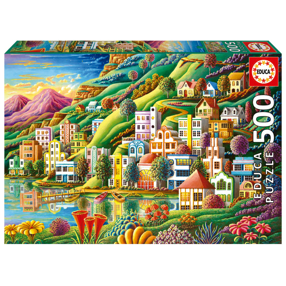 Educa jigsaw puzzle titled 'HIDDEN HARBOR' featuring a vibrant, colorful landscape with whimsical houses, lush green hills, and a serene lake reflecting the scene. The puzzle contains 500 pieces and showcases a variety of flowers and boats, enhancing the charming atmosphere of this imaginative setting.