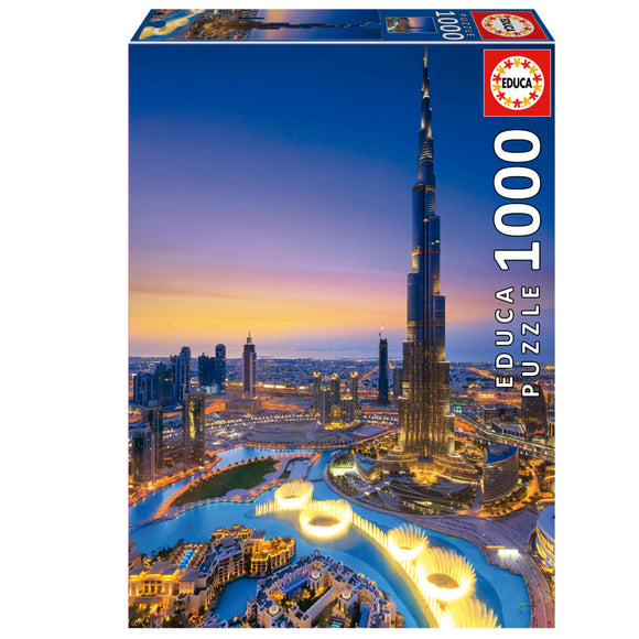 BURJ KHALIFA Jigsaw Puzzle by Educa featuring a stunning view of the iconic Burj Khalifa tower against a vibrant sunset skyline of Dubai, showcasing intricate architectural details. The puzzle contains 1000 pieces and is perfect for puzzle lovers and architecture enthusiasts alike.