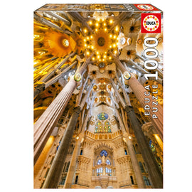 Box of the Sagrada Familia Interior jigsaw puzzle by Educa. The image showcases the stunning interior architecture of the Sagrada Familia with intricate columns and colorful stained glass windows. This 1000-piece jigsaw puzzle offers an immersive experience in recreating the iconic basilica's luminous design, perfect for puzzle enthusiasts and art lovers alike.