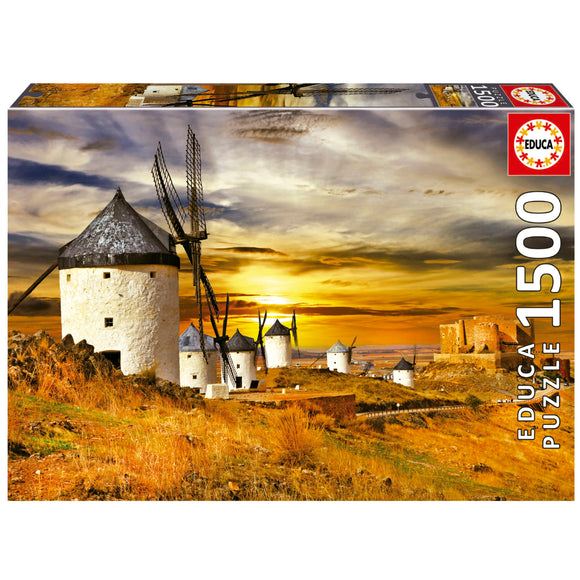 Educa jigsaw puzzle featuring a stunning sunset view of the iconic windmills of Consuegra, Spain. The image showcases a rustic landscape with five windmills on a hillside, a castle in the background, and golden fields under a dramatic sky. Perfect for puzzle enthusiasts, this 1500-piece puzzle invites creativity and provides a challenging yet enjoyable experience.