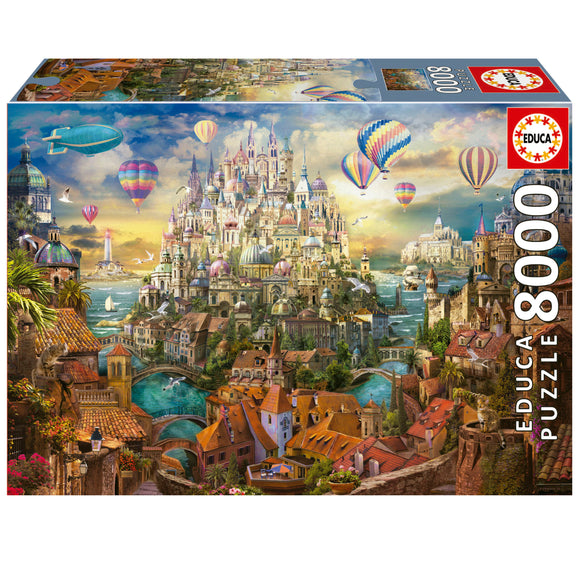DREAM TOWN jigsaw puzzle by Educa, featuring a vibrant, intricately illustrated fantasy landscape. The scene includes colorful hot air balloons, a majestic castle-like city, and scenic waterways surrounded by charming houses and lush greenery, designed for puzzle enthusiasts.
