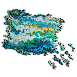 Small Marbling Infinity Green jigsaw puzzle by Nervous System, featuring intricate, swirling designs in shades of green, blue, and yellow. Several pieces are shown scattered around the partially completed puzzle, showcasing the unique cut shapes and vibrant colors.