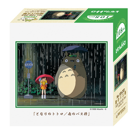 The Totoro Rain Bus Stop Petite Puzzle by Ensky features a serene scene from the beloved Studio Ghibli film. It depicts Totoro and a young girl standing under a bus stop in the rain, both holding umbrellas. The puzzle includes 108 pieces and showcases vibrant colors and detailed artwork, perfect for fans of animation and jigsaw puzzles.