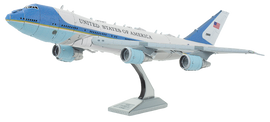 A detailed metal model of Air Force One, featuring intricate designs and a stand for display. The aircraft is painted with the iconic blue and white color scheme, showcasing 'United States of America' on its side. Perfect for enthusiasts and collectors.