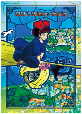 Colorful jigsaw puzzle featuring Kiki from Kiki's Delivery Service flying on her broom with her black cat, Jiji. The background depicts a vibrant townscape with greenery and water, reflecting the enchanting world of Studio Ghibli.