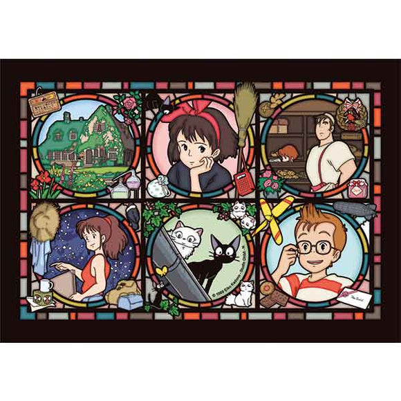 The Town of Koriko Art Crystal Puzzle featuring colorful illustrations of characters and scenes inspired by the beloved film. The image is divided into six panels showing charming depictions of various moments, including a young girl, animals, and whimsical elements, all framed in a decorative stained glass style design.