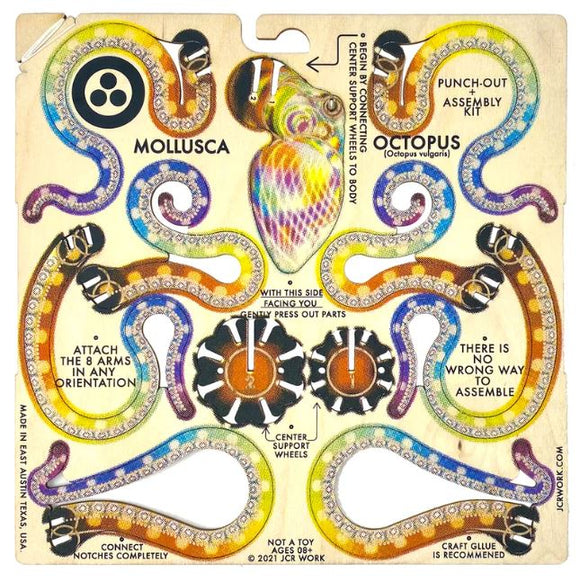 A DIY kit titled 'Mollusca: Octopus Rainbow' by JCR Work. The kit features colorful and intricate designs of octopus arms and body parts, with instructions for assembly. The punch-out pieces include vibrant illustrations of the octopus, encouraging creativity in how to attach the arms.