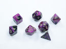 A set of Mini Gemini RPG dice featuring a black and purple color scheme with gold numbering. The seven dice include different shapes suitable for tabletop gaming.
