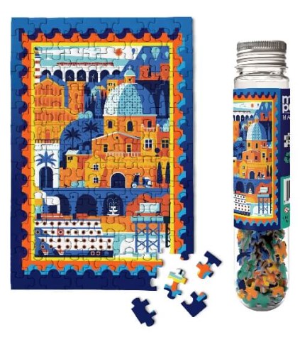 Micro Puzzle Mediterranean Vacation jigsaw puzzle. The image shows a vibrant scene with colorful buildings, domes, and palm trees, completed puzzle alongside puzzle pieces in a bottle.