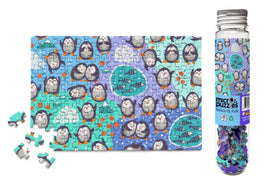 A colorful jigsaw puzzle featuring adorable penguins in various poses on an oceanic background. The puzzle is partially completed, displaying multiple penguin images against a blue and green backdrop. Next to the puzzle is a transparent container filled with loose jigsaw pieces, showing vibrant colors and patterns. Ideal for puzzle enthusiasts and animal lovers.