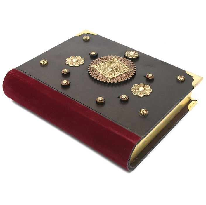 The Buch Box by Jean Claude is a beautifully crafted mechanical puzzle resembling an ornate book. It features a rich red velvet spine and intricate gold embellishments, with decorative flowers and a central medallion on the cover, perfect for challenging puzzle enthusiasts.