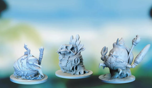 Three detailed miniature figures from the game Kiwi Chow Down by Detestable. The figures are intricately designed with unique features, each standing on a plain circular base. They display whimsical characteristics, including exaggerated facial features and thematic elements that suggest a playful, fantasy-inspired aesthetic.