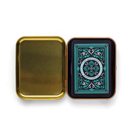 A stylish tin box opened to reveal a deck of Cocktail Playing Cards by Gentlemen's Hardware. The cards feature intricate designs with a blend of black and teal colors, emphasizing sophistication and elegance for gaming enthusiasts.
