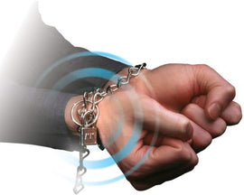 A close-up of a person's hands bound with a chain and padlock, demonstrating a magic trick. The image showcases the hands in a dramatic pose, with visual effects highlighting the magic element.