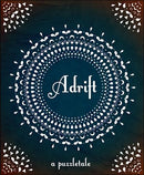 The cover of the game 'Adrift' by Postcurious featuring intricate white mandala designs on a deep blue background. The title 'Adrift' is elegantly scripted in the center, surrounded by decorative elements and the phrase 'a puzzletale' at the bottom.