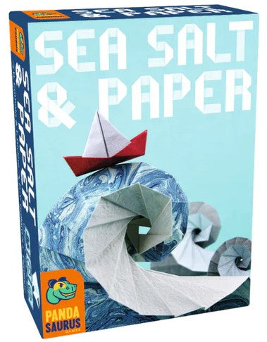 The game 'Sea Salt & Paper' by PANDASAURUS GAMES is presented in a colorful box featuring origami boats and waves. The design showcases a light blue background with intricate paper wave patterns and two paper boats, one red and one white. The box title is prominently displayed in bold, playful font.