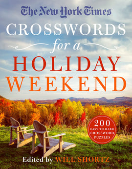 Cover of 'The New York Times Crosswords for a Holiday Weekend' featuring autumn scenery with two wooden chairs overlooking colorful trees and mountains. The title is prominently displayed, with '200 easy to hard crossword puzzles' noted at the bottom.