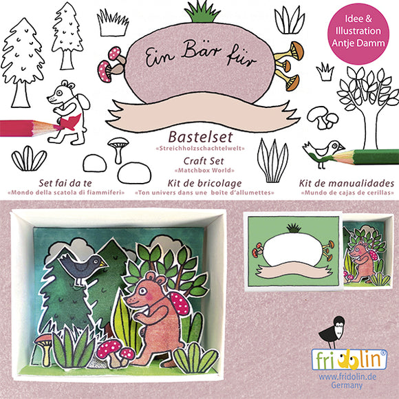 Fridolin Matchbox Kit featuring a forest scene with a bear and mushrooms. This DIY craft kit includes colorful illustrations of a bear, butterflies, and trees, encouraging creativity and imaginative play. The packaging displays the crafting tools and vibrant images to inspire children and adults alike.