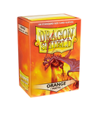 A package of Dragon Shields featuring 100 standard size matte orange card sleeves. The box is vividly illustrated with an image of a fierce dragon against a fiery background, highlighting its protective qualities for trading cards.