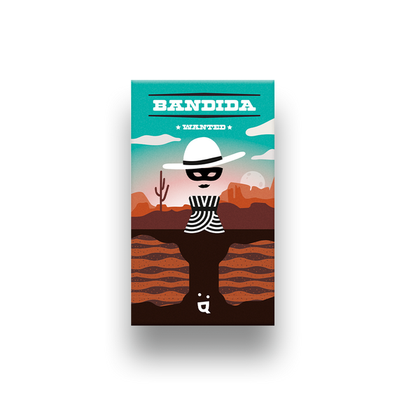 The game Bandida by Helvetiq features a visually striking design with a cartoon-style depiction of a bandit wearing a striped prison uniform and a wide-brimmed hat. The background showcases a desert landscape with cacti and rocky formations. The title 'BANDIDA' is prominently displayed at the top, along with the word 'WANTED'. This engaging and fun game invites players to immerse themselves in a thrilling chase.