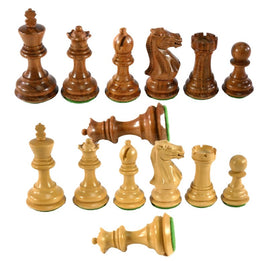 A set of 3-inch Kikkerwood and Natural chess pieces with chamfered bases displayed in two rows. The wooden chessmen feature a rich brown color and a natural finish, showcasing the king, queen, bishops, knights, rooks, and pawns. Each piece has a velvety green base, enhancing their elegant appearance. Perfect for chess enthusiasts and collectors.