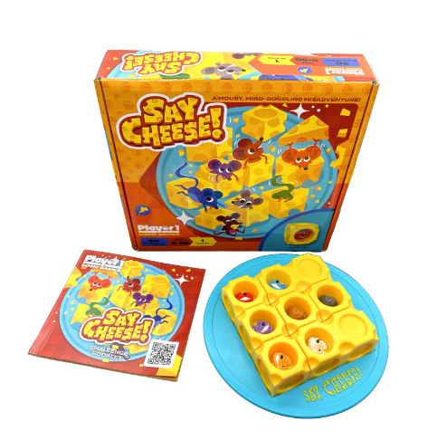Say Cheese! mechanical puzzle by Project Genius. The product features a vibrant box with cartoon cheese characters and a game board designed as a yellow cheese wheel. It includes bright-colored pieces and looks engaging, perfect for family fun or party entertainment.