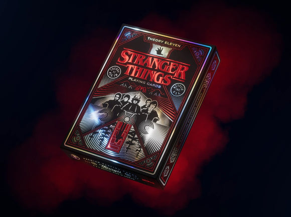The Stranger Things playing cards by Theory 11 feature a striking design with red and black accents. The box showcases iconic characters from the popular series, set against a mysterious background that captures the essence of the supernatural. Perfect for fans of the show, these cards combine nostalgia with quality craftsmanship for an engaging gaming experience.