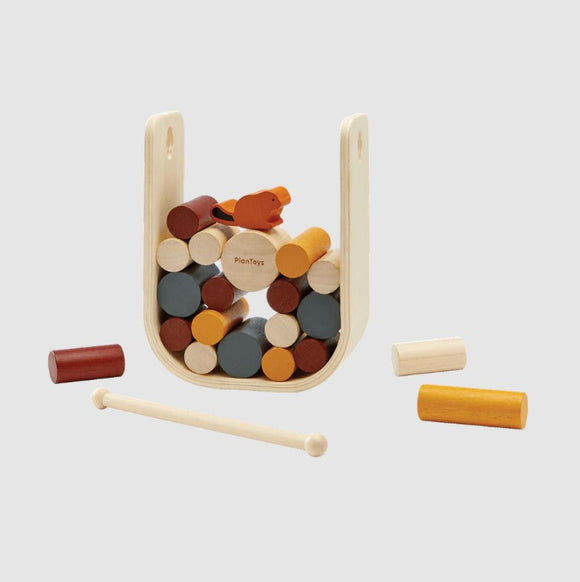 Plan Toys Beaver Tumble is a colorful mechanical puzzle featuring a playful beaver character surrounded by various wooden blocks in shades of red, yellow, and blue. Ideal for developing fine motor skills and problem-solving in children, this engaging toy combines fun and education.