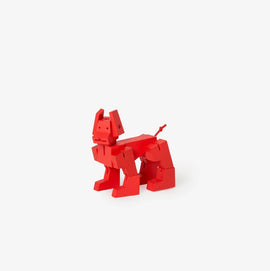 Cubebot Milo Micro in red color, a mechanical wooden toy designed to resemble a playful dog. It features movable joints and a unique modern design, perfect for creative play.