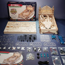 A detailed display of the Robotime 3D Pinball DIY kit, featuring an unassembled wooden pinball machine along with various components such as boards, mechanical parts, and tools. The kit is designed for building a classic pinball game with intricate details and multiple shooting score challenges. The packaging is showcased alongside the pieces, hinting at an engaging hands-on crafting experience.