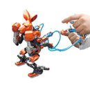 A DIY kit featuring hydraulic boxing bots designed by Thames & Kosmos. The image shows an orange robot with movable limbs being operated by a hand using a control system, highlighting its interactive nature and engineering features.
