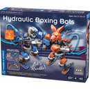 The Hydrolic Boxing Bots DIY kit by Thames & Kosmos, featuring a colorful box design. The image displays two hydraulic boxing robots, one gray and blue, the other orange and brown, positioned in a boxing stance with visible hydraulic controls. The box highlights key features like 'Let's Rumble!', 'Ultra-Responsive Hydraulic Controls', and is suitable for ages 10 and up. It includes 327 pieces for a challenging build.