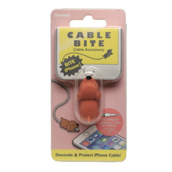 A packaging of the Cable Bite Dog iPhone accessory by Dreams USA. The product is a playful dog-shaped silicone cover designed to protect and decorate iPhone charging cables, with a vibrant pink background and images of the product in use with an iPhone. A small dog illustration reinforces the theme.