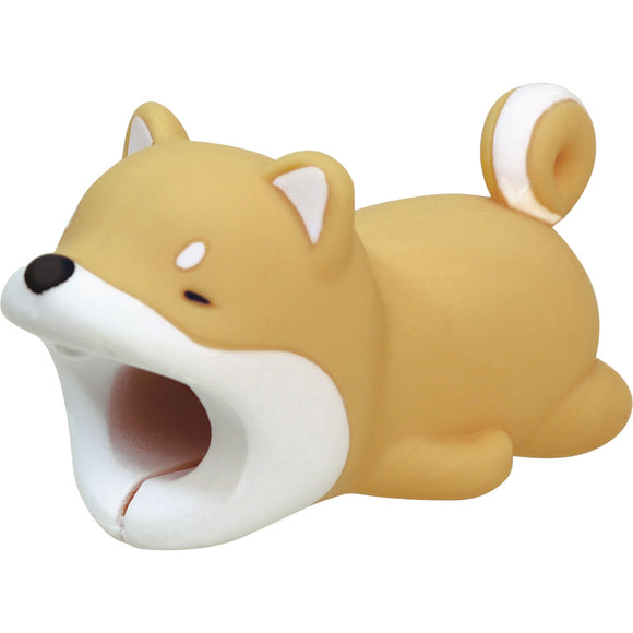 A cute Shiba Inu cable bite designed to look like a playful dog. The soft, rubbery material is tan with a white belly and details, featuring a mouth that fits over USB-C cables to protect them from fraying. Ideal for adding a fun, whimsical touch to your tech accessories.