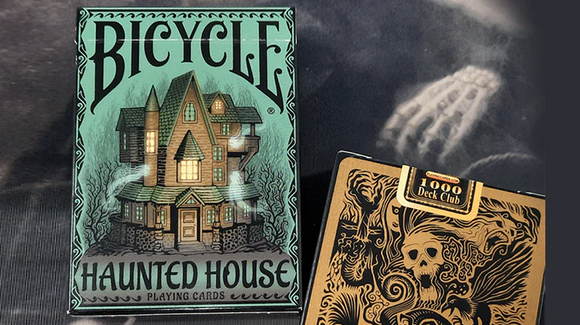Bicycle Haunted House playing cards featuring a spooky illustration of a haunted mansion, designed for thrilling gameplay and collectors. The box showcases intricate artwork in shades of green and black, emphasizing a Halloween theme.