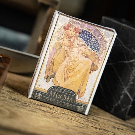 Mucha Princess Hyacinth Silver is a beautifully designed game featuring stunning artwork by Alphonse Mucha. The package showcases a graceful princess adorned in elegant attire, surrounded by intricate details that display the Art Nouveau style, making it an appealing choice for art enthusiasts and game lovers alike.