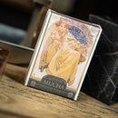 Mucha Princess Hyacinth Silver is a beautifully designed game featuring stunning artwork by Alphonse Mucha. The package showcases a graceful princess adorned in elegant attire, surrounded by intricate details that display the Art Nouveau style, making it an appealing choice for art enthusiasts and game lovers alike.