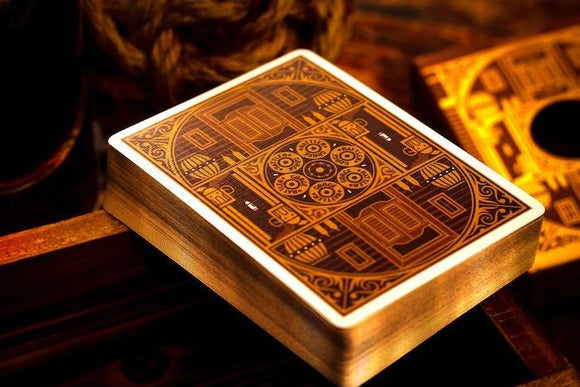Rattler Gorge playing cards in Desert Dust design, featuring intricate patterns and a warm color palette. The deck is displayed on a rustic wooden surface, enhancing its vintage appeal.