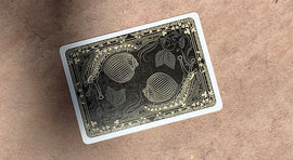 Bicycle Snail (Orange) Playing Cards featuring a unique design of snails and decorative elements on a black background, produced by US Playing Card Co. Ideal for card games and collectors.
