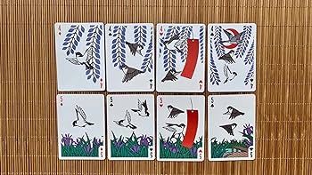 A display of several Bicycle Sparrow Hanafuda cards from US Playing Card Co. The cards feature beautiful illustrations of sparrows and floral designs, rendered in vibrant colors against a white background. The card faces showcase various symbols used in Hanafuda games, making them a perfect choice for both traditional and modern gameplay.