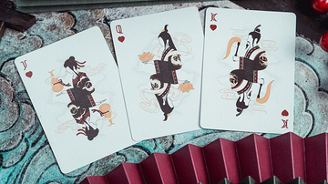 Pine Crane Playing Cards featuring J (Jack), Q (Queen), and K (King) cards. Each card showcases unique illustrations of animals and decorative elements, set against a textured background.