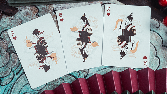 Pine Crane Playing Cards featuring J (Jack), Q (Queen), and K (King) cards. Each card showcases unique illustrations of animals and decorative elements, set against a textured background.