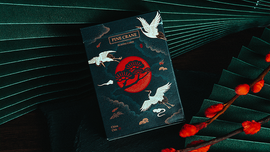 A beautifully designed deck of Pine Crane Playing Cards by Solokid. The packaging features a striking illustration of cranes against a dark background, embellished with red tones and traditional motifs. Perfect for card games and collectors alike.