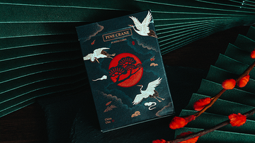 A beautifully designed deck of Pine Crane Playing Cards by Solokid. The packaging features a striking illustration of cranes against a dark background, embellished with red tones and traditional motifs. Perfect for card games and collectors alike.
