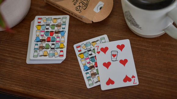 Roasters Coffee Shop Playing Cards featuring colorful coffee mug designs and hearts. The deck includes a unique 7 of hearts with a coffee cup illustration, perfect for game nights and coffee lovers.