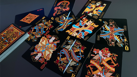 A spread of Goketsu Craft Playing Cards by Card Experiment, featuring elaborate illustrations of characters in vibrant colors against a black background. The cards display intricate designs that showcase a blend of artistry and culture, perfect for card games and collectors alike.